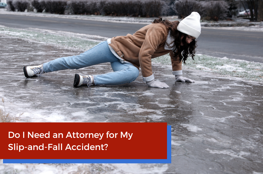 a woman trying to stand up after slipping and falling on an icy pavement outdoors