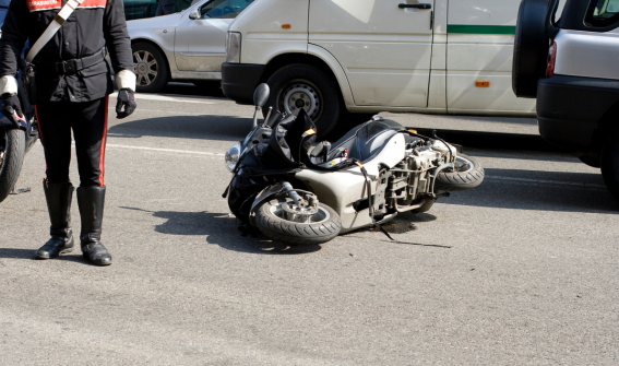 police investigating a scooter accident on a busy street